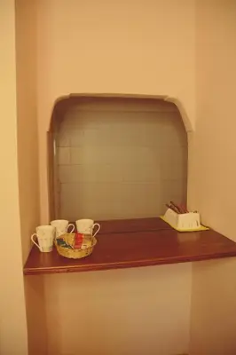 a shelf with three cups and a basket on it at Departamento espiral in Embalse