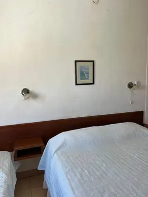 a bedroom with a bed and a picture on the wall at Departamento espiral in Embalse