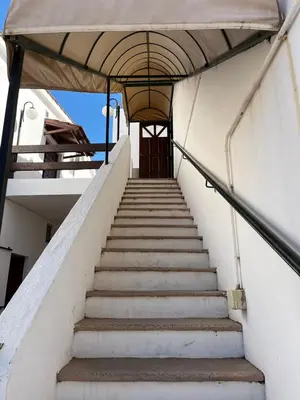 a stairway leading up to a building at Departamento espiral in Embalse