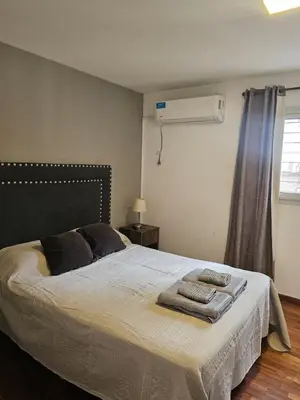 a bedroom with a bed with two towels on it at NelidaMaria in Cordoba