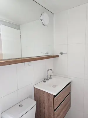 a bathroom with a sink and a toilet and a mirror at NelidaMaria in Cordoba