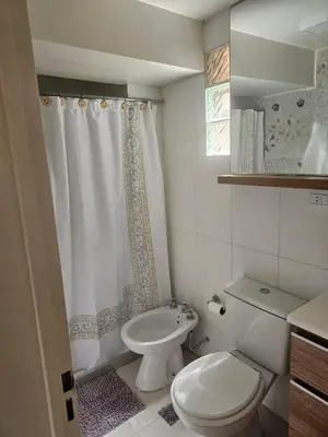 a bathroom with a toilet and a shower curtain at NelidaMaria in Cordoba