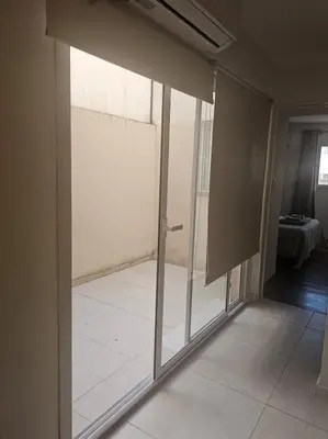 a sliding glass door in a room with a tile floor at NelidaMaria in Cordoba