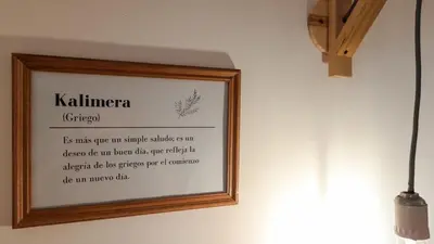 a picture in a wooden frame hanging on a wall at Kalimera Loft con patio, único en Córdoba Capital in Cordoba
