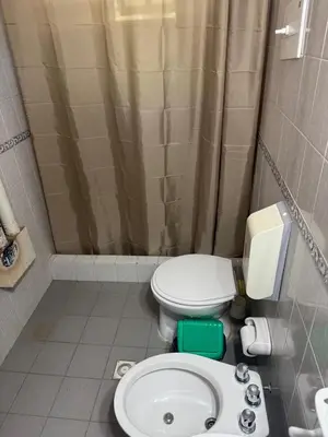 a bathroom with a toilet and a sink at Hostel Planeta Terminal VGB in Villa General Belgrano