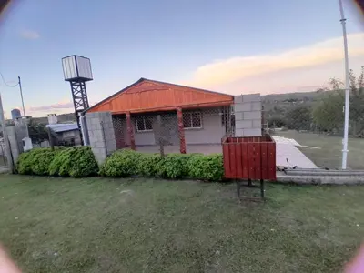 a small building with a water tower in front of it at Cabaña de montaña potrero de garay in Potrero de Garay