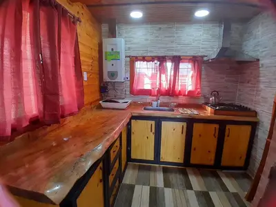 a kitchen with a wooden counter and a sink at Cabaña de montaña potrero de garay in Potrero de Garay