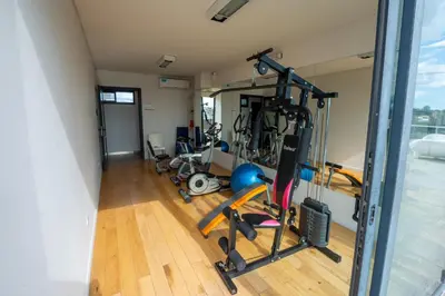 a gym with exercise equipment in a building at Gral Paz Apartment, Pileta Gym y vistas Unicas in Cordoba