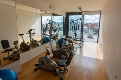 a gym with a bunch of exercise bikes in a room at Gral Paz Apartment, Pileta Gym y vistas Unicas in Cordoba