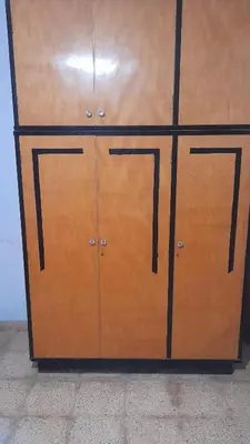 a wooden cabinet with two doors in a room at Habitacion en Casa de Olga in Alta Gracia