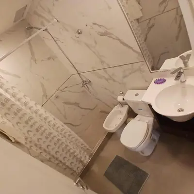 a bathroom with a sink and a toilet and a mirror at Ein gutes Haus in Mina Clavero