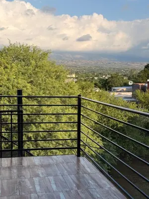 a balcony with a fence and a view at Casas de campo Traslasierra in Villa Cura Brochero