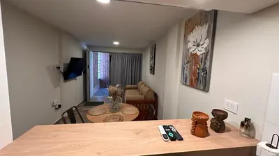 a living room with a table and a couch at Guarida Güemes Suite in Cordoba