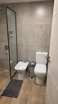 a bathroom with a toilet and a sink at Guarida Güemes Suite in Cordoba