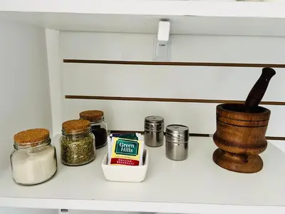 a shelf with spices and other items on it at Estadio Kempes Valle escondido Centro de Convenciones Amplio y Luminoso in Cordoba