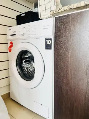 a white washing machine sitting in a room at Estadio Kempes Valle escondido Centro de Convenciones Amplio y Luminoso in Cordoba