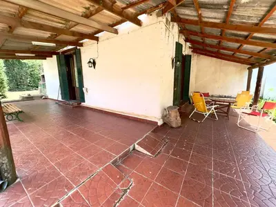 an empty patio with a table and chairs in a house at Villa il Fanale in Alpa Corral