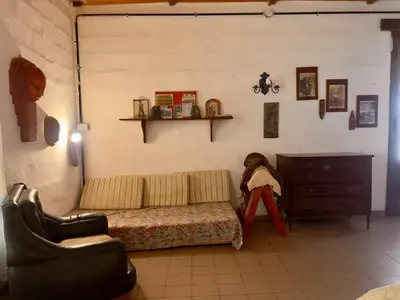 a living room with a couch and a dresser at Villa il Fanale in Alpa Corral