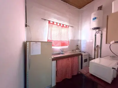 a small kitchen with a sink and a refrigerator at Villa il Fanale in Alpa Corral