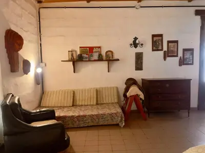 a living room with a couch and a dresser at Villa il Fanale in Alpa Corral