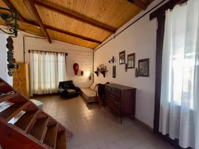 a living room with a couch and a window at Villa il Fanale in Alpa Corral