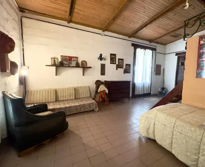 a living room with a couch and a bed at Villa il Fanale in Alpa Corral