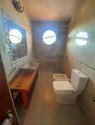 a small bathroom with a toilet and a sink at Casona de Montaña in Los Hornillos