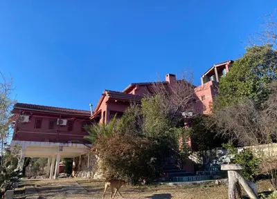 a house with a deer standing in front of it at Casona de Montaña in Los Hornillos