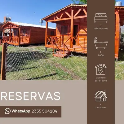 a log cabin with a fence in front of it at Cabañas para 4 personas M y M Cabañas in Villa Yacanto