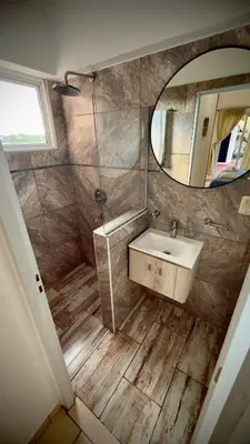 a bathroom with a sink and a mirror at Villa Las Medulas - Los Ancares Resort in Mina Clavero