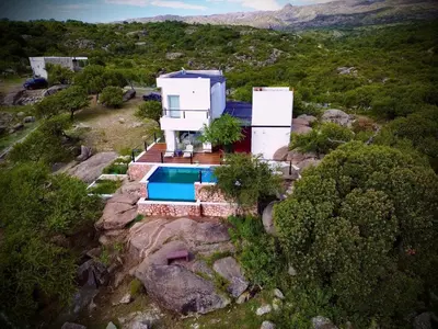 an aerial view of a house with a swimming pool at Villa Las Medulas - Los Ancares Resort in Mina Clavero