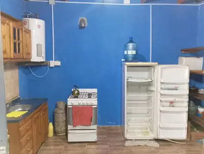 a small kitchen with a stove and a refrigerator at La Emi in Bialet Massé