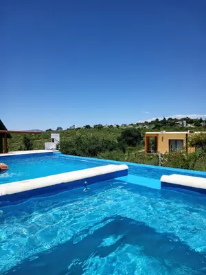 a swimming pool in a villa with a view at CABAÑAS L y L in Villa Santa Cruz del Lago