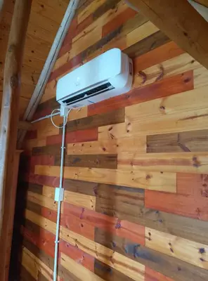 a room in a cabin with wood paneling at CABAÑAS L y L in Villa Santa Cruz del Lago