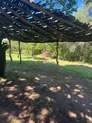 a wooden pergola in a field of grass at Hospedaje San Javier in San Javier