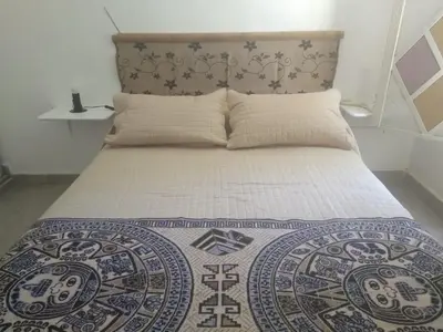 a bedroom with a bed with a bedspread on it at El Rincón Bucólico in Cordoba