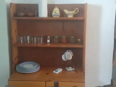 a wooden shelf with plates and dishes on it at El Rincón Bucólico in Cordoba