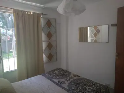 a bedroom with a bed and a window at El Rincón Bucólico in Cordoba