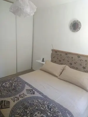a bedroom with a white bed with a patterned blanket at El Rincón Bucólico in Cordoba