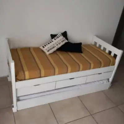 a white bed with two pillows on top of it at Departamento en Villa Carlos Paz edificio tempo! in Villa Carlos Paz