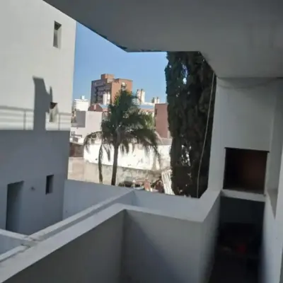 a view from the balcony of a building with palm trees at Departamento en Villa Carlos Paz edificio tempo! in Villa Carlos Paz