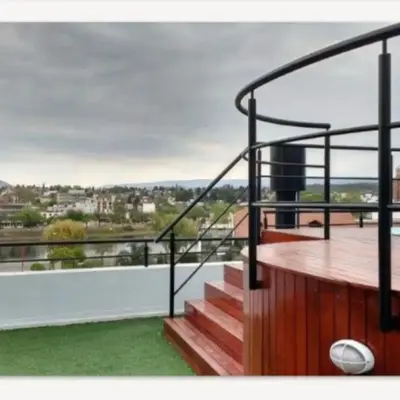 a balcony with stairs and a view of a city at Departamento en Villa Carlos Paz edificio tempo! in Villa Carlos Paz