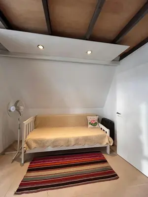 a bedroom with a bed with a rug on the floor at Selah in Villa de Las Rosas