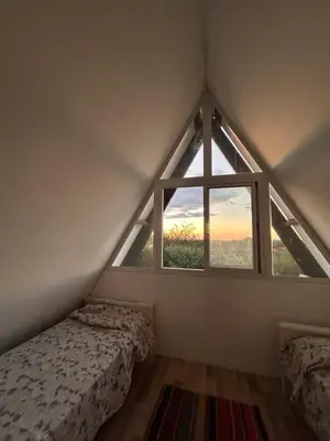 a room with two beds and a window at Selah in Villa de Las Rosas