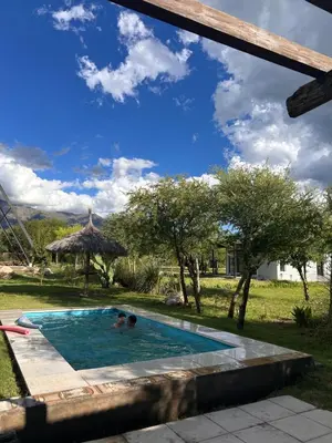 two people in a swimming pool in a yard at Selah in Villa de Las Rosas