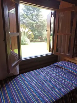 a room with a window with a bed and a view at Cabañas El Tala in La Bolsa