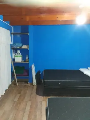 a room with a blue wall and a bed at La casona in Bialet Massé