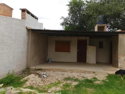 a dog standing in front of a house at La casona in Bialet Massé