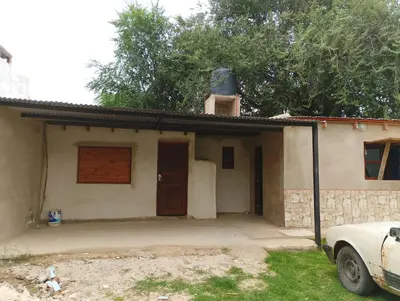 a house with a car parked in front of it at La casona in Bialet Massé