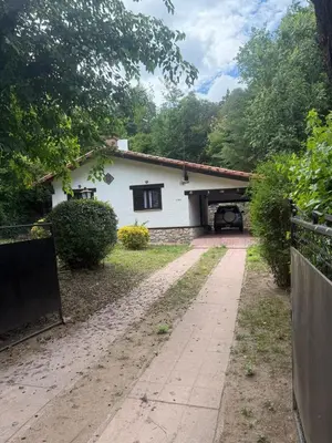 a white house with a driveway in front of it at Casa en La Falda, Córdoba in Cordoba